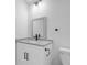 Bathroom featuring a granite countertop vanity with black hardware and modern fixtures at 614 Cummings Chapel Rd, Ridgeville, SC 29472