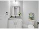 Cozy half bathroom features a granite countertop and stylish decor at 614 Cummings Chapel Rd, Ridgeville, SC 29472