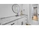 Bright bathroom featuring granite countertop and black hardware with modern fixtures and round mirror at 614 Cummings Chapel Rd, Ridgeville, SC 29472