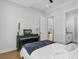Bright bedroom with wood floors features a ceiling fan and doorway with trim at 614 Cummings Chapel Rd, Ridgeville, SC 29472