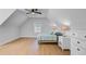 Bright bedroom features a ceiling fan, hardwood floors, a light blue bedspread, and crisp white walls at 614 Cummings Chapel Rd, Ridgeville, SC 29472