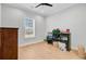 Bedroom with wood floors features a double window with natural light, ceiling fan, and small desk at 614 Cummings Chapel Rd, Ridgeville, SC 29472