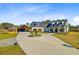 Beautiful two-story home with a circular driveway and detached garage and carport at 614 Cummings Chapel Rd, Ridgeville, SC 29472