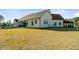 Wide shot of the home's exterior, showcasing the large backyard and covered outdoor entertaining area at 614 Cummings Chapel Rd, Ridgeville, SC 29472