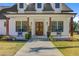 Charming front porch with rocking chairs and a decorative front door at 614 Cummings Chapel Rd, Ridgeville, SC 29472