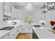 This kitchen showcases white cabinets, modern appliances, a farmhouse sink, and ample counter space at 614 Cummings Chapel Rd, Ridgeville, SC 29472