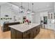 A spacious kitchen with a large island connects to the living room, creating an open and inviting living space at 614 Cummings Chapel Rd, Ridgeville, SC 29472