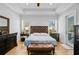 Spacious main bedroom featuring hardwood floors, tray ceiling, and lots of natural light at 614 Cummings Chapel Rd, Ridgeville, SC 29472