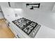 A stainless steel ZLINE gas cooktop on a white countertop with a white backsplash and black accents at 614 Cummings Chapel Rd, Ridgeville, SC 29472