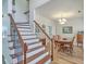 Elegant dining area adjacent to staircase with wood floors and iron railing at 628 Alwyn Blvd, Summerville, SC 29485