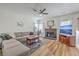 Bright living room with a fireplace, cozy sectional sofa, and modern ceiling fan at 628 Alwyn Blvd, Summerville, SC 29485