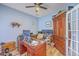 Well-lit home office with hardwood floors, custom desk, cabinets, and a ceiling fan at 628 Alwyn Blvd, Summerville, SC 29485