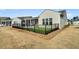 Backyard with screened porch, fenced-in area with artificial turf, and a pristine lawn at 663 Marsh Cove Cir, Summerville, SC 29486