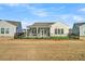 Expansive backyard featuring a screened porch and fenced-in area with artificial turf at 663 Marsh Cove Cir, Summerville, SC 29486