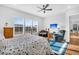 Bedroom with wood floors, large windows, ceiling fan, and a comfortable seating area at 663 Marsh Cove Cir, Summerville, SC 29486