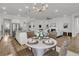 Bright dining area with modern chandelier and adjacent kitchen and living spaces at 663 Marsh Cove Cir, Summerville, SC 29486