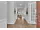 Bright foyer with wood flooring, white trim, and an open view into the home at 663 Marsh Cove Cir, Summerville, SC 29486
