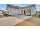 Attractive one-story home featuring a two-car garage, red front door, and a comfortable porch at 663 Marsh Cove Cir, Summerville, SC 29486