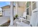 Inviting front porch featuring white rocking chairs and decorative plants, next to a two-car garage at 663 Marsh Cove Cir, Summerville, SC 29486