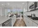 Spacious kitchen island with quartz countertops, modern fixtures, and an adjacent dining space at 663 Marsh Cove Cir, Summerville, SC 29486