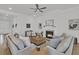 Inviting living room with a fireplace, neutral furnishings, and a ceiling fan at 663 Marsh Cove Cir, Summerville, SC 29486