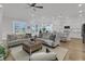 Open-concept living room with a ceiling fan, modern lighting, and access to the kitchen and dining areas at 663 Marsh Cove Cir, Summerville, SC 29486