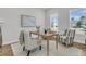 Cozy office space with a neutral color scheme, comfortable chairs, and natural light from the window at 663 Marsh Cove Cir, Summerville, SC 29486