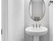 Modern powder room showcasing a pedestal sink and stylish mirror at 663 Marsh Cove Cir, Summerville, SC 29486