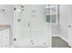 Modern bathroom shower with clear glass enclosure, built-in bench, and sleek fixtures at 663 Marsh Cove Cir, Summerville, SC 29486