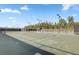 An expansive community tennis court has mature trees in the background for a scenic sports experience at 663 Marsh Cove Cir, Summerville, SC 29486