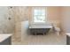 Bathroom features clawfoot tub, tiled walk-in shower, and a window view at 708 S Laurel St, Summerville, SC 29483