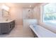 This elegant bathroom offers a marble shower, clawfoot tub, and vanity sink at 708 S Laurel St, Summerville, SC 29483