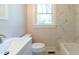 Bathroom showcasing vanity sink, toilet, and walk-in tiled shower with a window at 708 S Laurel St, Summerville, SC 29483