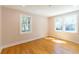 Bedroom with hardwood floors, and natural light shining through two windows at 708 S Laurel St, Summerville, SC 29483