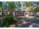 Charming single-story home featuring a welcoming front yard and a quaint exterior with a light pink facade and natural light at 708 S Laurel St, Summerville, SC 29483