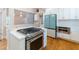Modern kitchen featuring stainless steel appliances, white cabinets, stone countertops and hardwood floors throughout at 708 S Laurel St, Summerville, SC 29483