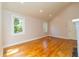 Airy living room with vaulted ceilings, hardwood floors and lots of natural light from large windows throughout at 708 S Laurel St, Summerville, SC 29483