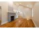 Spacious living area boasts vaulted ceilings and a painted brick fireplace, enhanced by gleaming hardwood floors and natural light at 708 S Laurel St, Summerville, SC 29483