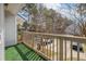 Balcony overlooking wooded area with green outdoor carpet and wood railing at 7814 Nummie Ct, North Charleston, SC 29418