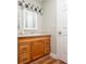 Bathroom vanity features wood cabinets, granite countertop, white sink and updated lighting fixtures at 7814 Nummie Ct, North Charleston, SC 29418