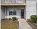 Townhouse entrance with dark front door and manicured landscaping at 7814 Nummie Ct, North Charleston, SC 29418