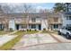 White townhomes in a community with well-manicured lawns and ample parking at 7814 Nummie Ct, North Charleston, SC 29418
