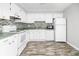 Bright kitchen featuring wood flooring, white appliances, and a mosaic backsplash at 7814 Nummie Ct, North Charleston, SC 29418