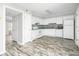 Bright kitchen featuring wood flooring, white appliances, and a white backsplash at 7814 Nummie Ct, North Charleston, SC 29418