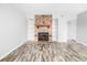 Living room featuring stone fireplace with built-ins and hardwood flooring at 7814 Nummie Ct, North Charleston, SC 29418
