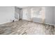 Open living area with wood-look floors and a view of the staircase at 7814 Nummie Ct, North Charleston, SC 29418
