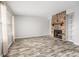 Open-concept living room with hardwood floors and a cozy stone fireplace at 7814 Nummie Ct, North Charleston, SC 29418