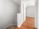 Carpeted staircase leads to upstairs hallway with wood-look flooring and white doors at 7814 Nummie Ct, North Charleston, SC 29418
