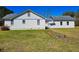 Back of the home with a well-kept lawn at 8524 Cane Branch Rd, Ruffin, SC 29475