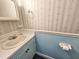 Cozy bathroom featuring a pedestal sink, floral wallpaper, and beadboard paneling at 8524 Cane Branch Rd, Ruffin, SC 29475